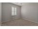 Bright bedroom featuring neutral walls, carpet floors, and windows with white shutters at 4289 E Jasper Dr, Gilbert, AZ 85296