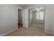 Bright bedroom featuring carpet, closet with mirrored doors, ceiling fan, and view to bathroom at 4289 E Jasper Dr, Gilbert, AZ 85296