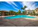 Expansive community pool with sunning chairs, covered patio, and beautiful landscaping for resident enjoyment at 4289 E Jasper Dr, Gilbert, AZ 85296