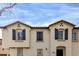 Beautiful townhome features symmetrical windows and a stucco exterior under a blue sky at 4289 E Jasper Dr, Gilbert, AZ 85296