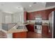 Kitchen with granite countertops, stainless steel appliances, and wooden cabinetry at 4289 E Jasper Dr, Gilbert, AZ 85296