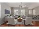 Bright living room featuring modern furnishings, a ceiling fan, and shuttered windows for natural light at 4289 E Jasper Dr, Gilbert, AZ 85296