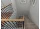 Staircase with carpet steps, wooden railing, and black iron balusters at 4289 E Jasper Dr, Gilbert, AZ 85296