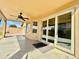 An expansive covered patio featuring a ceiling fan and multiple glass doors for seamless indoor-outdoor living at 4349 E Encinas Ave, Gilbert, AZ 85234