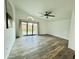 Bright living room with hardwood floors, a ceiling fan, and sliding glass doors leading to the backyard at 4349 E Encinas Ave, Gilbert, AZ 85234