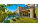 Beautiful backyard featuring a pool, artificial turf, patio, and well-maintained landscaping at 4611 E Casitas Del Rio Dr, Phoenix, AZ 85050