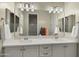 Bright bathroom with a double vanity, white countertops, and modern fixtures at 4611 E Casitas Del Rio Dr, Phoenix, AZ 85050