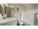 Bright bathroom featuring a vanity, tub and shower combination, and arched window at 4611 E Casitas Del Rio Dr, Phoenix, AZ 85050