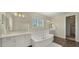 Bathroom featuring a soaking tub, double vanity, and wood-style tile floors at 4611 E Casitas Del Rio Dr, Phoenix, AZ 85050