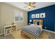 Colorful bedroom features a striped comforter, nautical wall decorations and a cheerful blue accent wall at 4611 E Casitas Del Rio Dr, Phoenix, AZ 85050