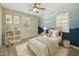 Cozy bedroom features a mountain mural, a striped comforter and plenty of sunshine at 4611 E Casitas Del Rio Dr, Phoenix, AZ 85050