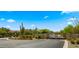Community entrance with stone pillars, an iron gate, desert landscaping and a blue sky at 4611 E Casitas Del Rio Dr, Phoenix, AZ 85050