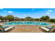 Beautiful community pool surrounded by a brick patio, lounge chairs and lush landscaping at 4611 E Casitas Del Rio Dr, Phoenix, AZ 85050