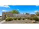 Stone monument sign for Sanctuary Desert Resort with desert landscaping and clear blue sky at 4611 E Casitas Del Rio Dr, Phoenix, AZ 85050