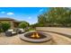 Beautiful backyard includes a cozy fire pit with stone surround and seating, perfect for outdoor entertaining at 4611 E Casitas Del Rio Dr, Phoenix, AZ 85050