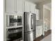 Close up of kitchen with stainless steel appliances, modern microwave, and cooktop at 4611 E Casitas Del Rio Dr, Phoenix, AZ 85050