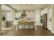 Bright kitchen boasts white cabinets, stainless steel appliances, pendant lighting, and a center island with bar stool seating at 4611 E Casitas Del Rio Dr, Phoenix, AZ 85050