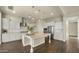 Bright, open kitchen boasts white cabinetry, a large island, stainless steel appliances, and stylish pendant lighting at 4611 E Casitas Del Rio Dr, Phoenix, AZ 85050