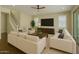 Inviting living room featuring recessed lighting, neutral color palette, plush seating, and a staircase at 4611 E Casitas Del Rio Dr, Phoenix, AZ 85050