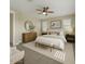 Neutral main bedroom offers a ceiling fan, a wall mirror, plantation shutters and a restful decor at 4611 E Casitas Del Rio Dr, Phoenix, AZ 85050