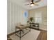 Comfortable home office offers modern wallpaper, a ceiling fan, neutral carpeting and shutters on the window at 4611 E Casitas Del Rio Dr, Phoenix, AZ 85050