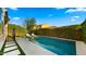 Backyard pool with lounge chairs, tiled deck, and privacy landscaping at 4611 E Casitas Del Rio Dr, Phoenix, AZ 85050