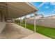 A back patio features a covered area and well-maintained synthetic grass at 4739 W Paradise Ln, Glendale, AZ 85306