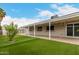 A back patio features a covered area and well-maintained synthetic grass at 4739 W Paradise Ln, Glendale, AZ 85306