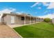 A covered back patio and well-manicured synthetic lawn is perfect for entertaining at 4739 W Paradise Ln, Glendale, AZ 85306