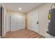 Finished basement with laminate flooring featuring built-in storage and utility access at 4739 W Paradise Ln, Glendale, AZ 85306
