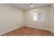An empty bedroom featuring laminate flooring, neutral paint, and a white window at 4739 W Paradise Ln, Glendale, AZ 85306
