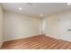 An open bedroom featuring laminate flooring, neutral paint, and modern trim at 4739 W Paradise Ln, Glendale, AZ 85306