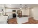 Updated kitchen features white cabinets, a dark countertop island, stainless appliances, and modern lighting at 4739 W Paradise Ln, Glendale, AZ 85306
