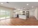 Open kitchen with stainless appliances, white cabinets, modern pendant lights, and sliding glass door to backyard at 4739 W Paradise Ln, Glendale, AZ 85306