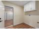 A large laundry room featuring built-in storage cabinets with neutral paint and laminate flooring at 4739 W Paradise Ln, Glendale, AZ 85306