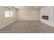 Bright living room featuring a modern fireplace and plush carpeting at 4739 W Paradise Ln, Glendale, AZ 85306