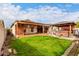 Lush backyard featuring a well-maintained lawn, a covered patio, and a hot tub gazebo at 535 E Yellow Wood Ave, San Tan Valley, AZ 85140