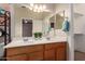 Bathroom with double sinks, wood cabinets, and a large mirror with vanity lighting at 535 E Yellow Wood Ave, San Tan Valley, AZ 85140