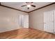 Bedroom with wood-look flooring and neutral paint, leading to a bathroom at 535 E Yellow Wood Ave, San Tan Valley, AZ 85140
