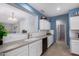 Kitchen features white cabinets, gray countertops, subway tile backsplash, and stainless steel appliances at 535 E Yellow Wood Ave, San Tan Valley, AZ 85140