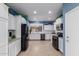 Bright kitchen boasts white cabinets, stainless steel appliances, and tiled floor at 535 E Yellow Wood Ave, San Tan Valley, AZ 85140