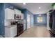 Kitchen featuring white cabinets, modern appliances, and eat-in dining area at 535 E Yellow Wood Ave, San Tan Valley, AZ 85140