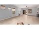 A spacious living room with neutral paint, tile flooring, ceiling fan, and outdoor access at 535 E Yellow Wood Ave, San Tan Valley, AZ 85140