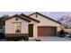 Charming single-story home with a two-car garage, manicured landscaping, and neutral exterior paint at 5640 S 253Rd Ave, Buckeye, AZ 85326