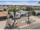 Attractive single-story home featuring desert landscaping and mature palm trees at 6241 E Adobe Rd, Mesa, AZ 85205