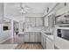 A cozy kitchen with white appliances, grey cabinets, tile backsplash, and a ceiling fan at 6241 E Adobe Rd, Mesa, AZ 85205