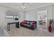 A cozy living room with tile floors, a black couch with red pillows, and an adjacent dining area at 6241 E Adobe Rd, Mesa, AZ 85205