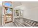 Inviting entryway with stylish gray wood-look floors, high ceilings, large windows, and secure front door at 6436 W Wahalla Ln, Glendale, AZ 85308