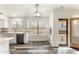 Bright eat-in kitchen features gray wood floors, stainless steel appliances, and a modern light fixture at 6436 W Wahalla Ln, Glendale, AZ 85308