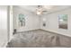 Spacious main bedroom with large windows, a ceiling fan, and neutral carpeting at 6436 W Wahalla Ln, Glendale, AZ 85308